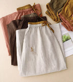 Jupe mi-longue femme trapèze taille haute, broderies et poches