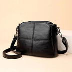 Petit sac bandoulière femme noir en similicuir, poches zippées