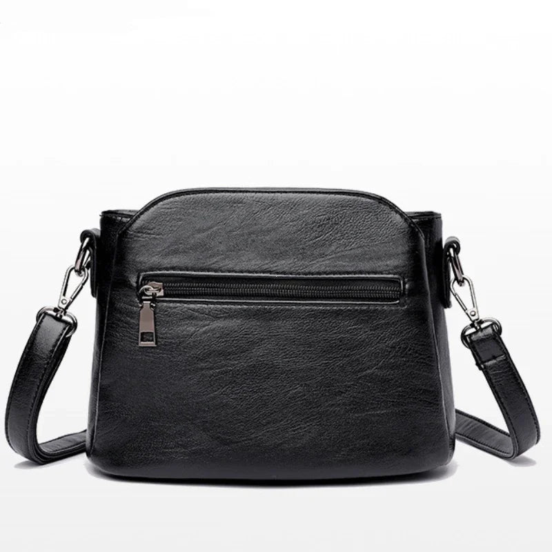 Petit sac bandoulière femme noir en similicuir, poches zippées
