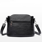 Petit sac bandoulière femme noir en similicuir, poches zippées