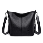 Sac bandoulière femme noir en similicuir grainé, forme trapèze