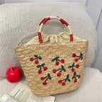 Sac en paille brodé femme, motifs fruits et plage, à cordon