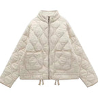 Veste matelassée femme zippée à poches, piqûres arrondies, abricot